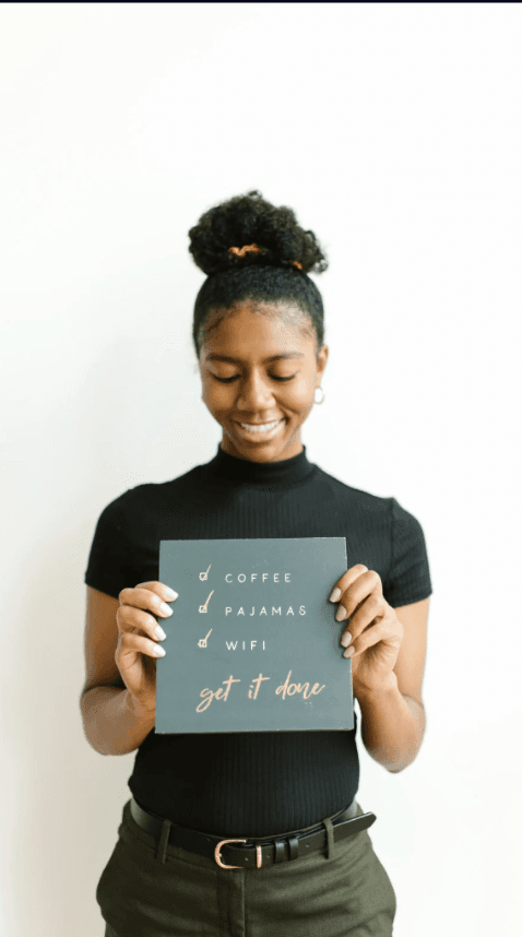 Woman holding get it done sign